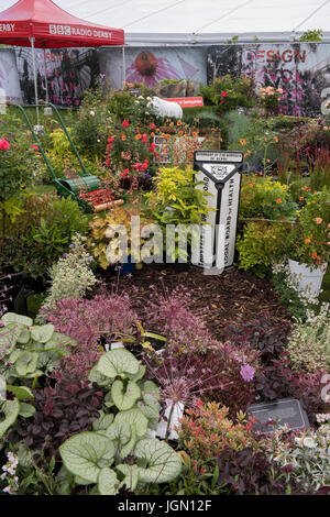 Piante, arbusti, tosaerba & post di confine nel display della BBC garden - RHS Chatsworth Flower Show showground, la Chatsworth House, Derbyshire, Inghilterra, Regno Unito. Foto Stock