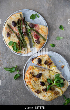 Il duo della Pizza, base bianca pizza, prosciutto di Parma, asparagi e olive, crescione guarnire base bianca pizza, formaggio di capra, Apple, le noci e le olive, agnello le Foto Stock