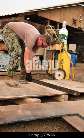 Petty Officer 2a classe Nicholas Baldus, un Mobile navali di costruzione un battaglione Seabee distribuito con Combined Joint Task Force - Corno d Africa, prepara un ossigeno acetilene-attrezzatura di saldatura per creare i chiusini di acciaio a Camp Lemmonier, Gibuti, Luglio 7, 2017. I coperchi sono per un Arta-regione clinica medica che CJTF-HOA è la costruzione in collaborazione continua con il popolo abitante del Gibuti. (U.S. Air National Guard foto di Tech. Sgt. Andria Allmond) Foto Stock