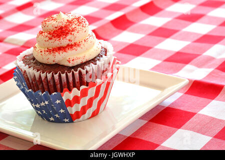 Red Velvet cupcake in formato orizzontale con patriottici rosso, bianco e blu cupcake liner su rosso e bianco panno controllati Foto Stock