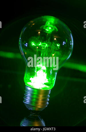 Concetto classico di lampadina spia di alimentazione verde con raggi laser.