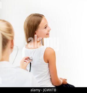 Medico con stetoscopio e ragazza in ospedale Foto Stock