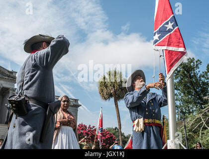 La Colombia, Sud Carolina, Stati Uniti d'America. 10 lug 2017. Reenactor confederato Braxton Spivey, di Charleston, Carolina del Sud è affiancato da un collega reenactor e celebrità confederato nero Arlene Barnum di Stuart, Oklahoma come egli solleva un confederato bandiera fino a bandiera portatile pole durante la bandiera Confederate sollevamento evento organizzato dalla Carolina del Sud partito secessionista in segno di protesta dei due anni di anniversario della battaglia Confederati Bandiera della rimozione dal South Carolina State House motivi nel 2015. Credito: schiacciare il lettore Rush/Alamy Live News Foto Stock