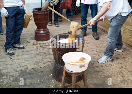 Giapponese fresca mochi essendo pestate utilizzando legno tradizionale e di usu vacche (grande mortaio e pestello), mochi riso torta fatta in occasione di una cerimonia chiamato mochitsu Foto Stock