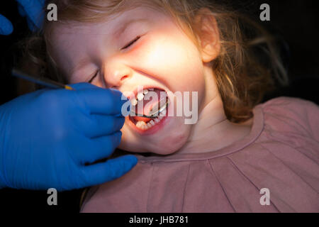 Il Toddler girl / 2 o 3 anni / due o tre anni di bambino durante il check up con il dentista per bambini / bambini pratica dentale. Regno Unito Foto Stock