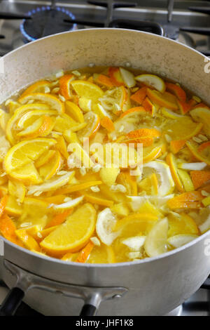 Fette di arance e di limoni in pentola per la produzione di marmellate fatte in casa Foto Stock