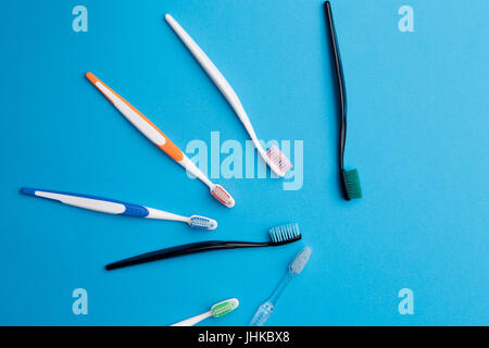 Immagine di toothbrushs disposte a semicerchio su sfondo blu,luogo per l'iscrizione Foto Stock