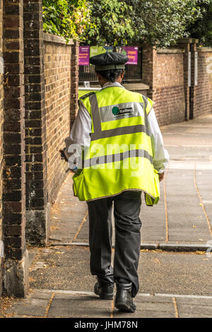 Un London Borough of Ealing vigile camminando giù un Ealing, London street, Inghilterra, Regno Unito. Foto Stock