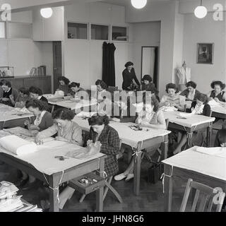 1948, storico, Inghilterra, immagine mostra le studentesse in una classe di cucitura ad una formazione insegnanti college, con un insegnante di supervisionare un studente utilizzando una macchina da cucire. Foto Stock