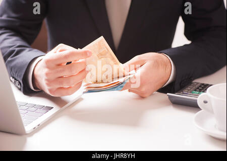 Man in black suit conta denaro euro Foto Stock