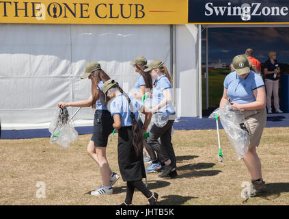 Southport, Merseyside, scuola di volontariato bambini reclutati da una vicina scuola visita al Royal Birkdale Golf Club durante il campionato aperto su una gita per raccogliere la spazzatura e impegnarsi in cucciolata pick up. In dotazione con i selettori di lettiera & cancella i sacchetti di plastica le ragazze e i ragazzi sono stati messi al lavoro per cancellare la zona di scartare spazzatura, plastica, residui di carta e il loro riempimento di sacchi della spazzatura. La gente desidera prelevare lettiera per aiutare l'ambiente, rendendo la comunità avrà un aspetto migliore e scoraggiare ulteriori littering. Lattine di soda, sacchetti di plastica e mozziconi di sigaretta cucciolata l'ambiente & soffocare la fauna selvatica Foto Stock