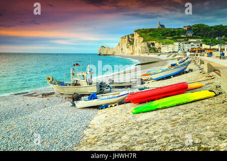 Incredibile normandian litorale di ciottoli bianchi con pietre Magico tramonto e barche colorate, Etretat, in Normandia, Francia, Europa Foto Stock