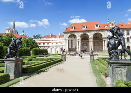 Statue lungo un vicolo e le persone di fronte alla Sala Terrena (padiglione del giardino) al Wallenstein (Waldstein) Giardino a Praga, Repubblica Ceca. Foto Stock