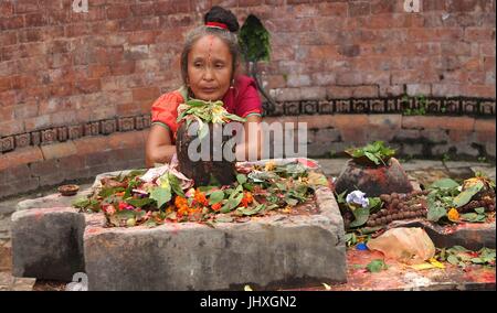 Kathmandu, Nepal. 17 Luglio, 2017. Una donna Indù offre preghiere su Shrawan Somvar al tempio di Pashupatinath a Kathmandu, Nepal, luglio 17, 2017. Lunedì o Somvar nel mese di Shrawan sono considerate di buon auspicio per donne Indù come essi veloce ed offrire preghiere al Signore Shiva per la lunga e prosperosa vita per i loro mariti o la possibilità di trovare una buona. Credito: Sunil Sharma/Xinhua/Alamy Live News Foto Stock