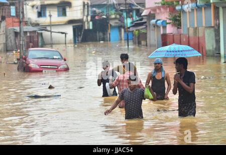 Dimapur, India. 19 Luglio, 2017. Indian residenti wade attraverso allagato residente presso Dhobinala in Dimapur, India nord orientale di stato del Nagaland. Incessanti piogge monsoniche nella regione per effetto della normale vita causando inondazioni e frane il taglio dell'autostrada nazionale. Credito: Caisii Mao/Alamy Live News Foto Stock