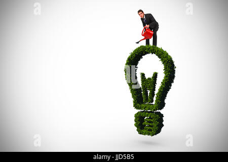 Imprenditore con irrigazione red può contro la lampadina di luce fatto di foglie Foto Stock
