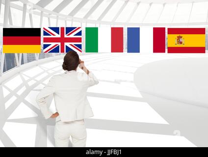 Composito Digitale della lingua principale flags over imprenditrice in ufficio Foto Stock