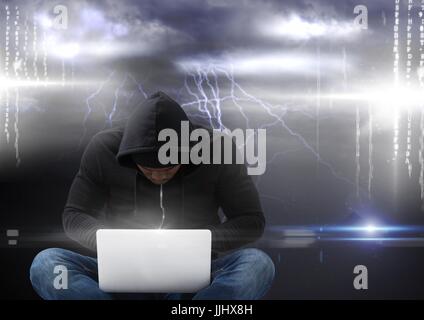 Hacker con seduti con le gambe incrociate usando un computer portatile nella parte anteriore del background storm Foto Stock