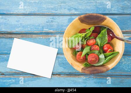 Business card blu sulla scrivania in legno con cibo e spazio copia su carta Foto Stock