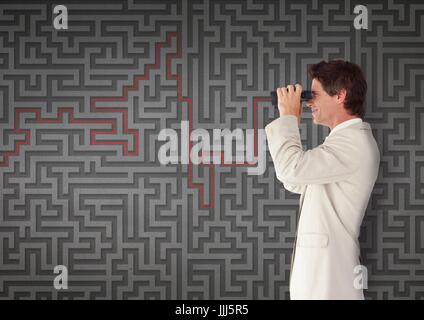 Uomo che guarda attraverso il binocolo contro 3d sfondo maze Foto Stock