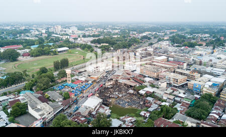 Vecchia casa comunitaria dopo il fuoco nella città capitale vicino a punto di riferimento del centro di "Phra Prang Sam Yot' in Lop Buri Thailandia, vista dall'alto e prendere da fuco Foto Stock