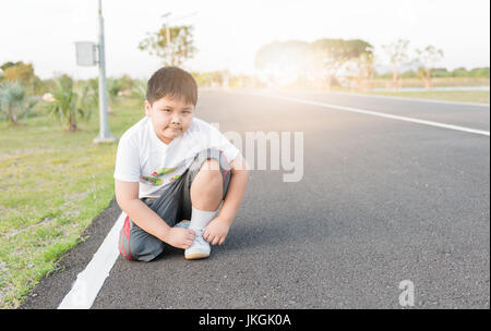 Obesi asiatici fat boy lacci scarpa sportiva. concetto esercizio dieta e sana Foto Stock