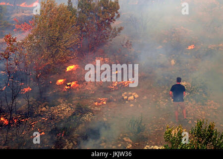 Zrnovnica, Split, Croazia - Luglio 17, 2017: uomo in conflitto con la massiccia fuochi bruciare la foresta e i villaggi intorno la città di Spalato Foto Stock