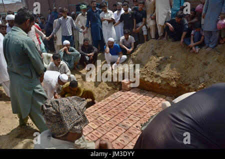 Lahore, Pakistan. 26 Luglio, 2017. Il pakistan parenti delle due vittime blast polizia fratelli Ali Raza e Ghulam Murtaza che subirono il martirio nel suicidio mortale di BLAST su Ferozepur Road vicino al Arfa Karim Tower, piange durante la loro cerimonia di sepoltura di Lahore. Una esplosione rivendicato da Tehreek-e-talebani in Pakistan (TTP) ucciso almeno 29 persone e il ferimento di decine in un affollato mercato ortofrutticolo nella città pakistana di Lahore. Credito: Rana Sajid Hussain/Pacific Press/Alamy Live News Foto Stock