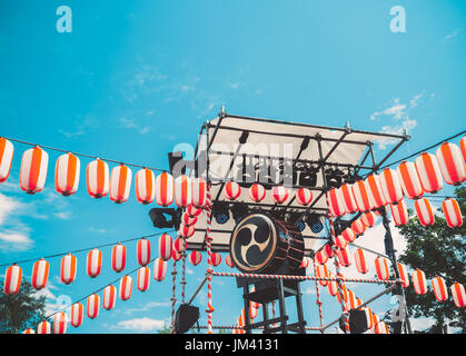 Tamburo giapponese Taiko sul palco del Yaguro. Carta rosso-bianco fanali Chochin scenario per la vacanza Obon. Foto Stock