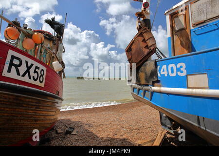 HASTINGS, Regno Unito - 22 luglio 2017: Spiaggia lanciato coloratissime barche di pescatori con un bellissimo cielo Foto Stock