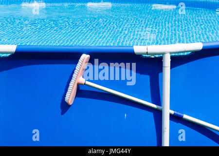 Home piscina con la spazzola di pulizia fissato Foto Stock
