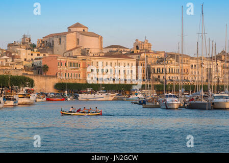 Siracusa Sicilia, vista di un equipaggio di canottaggio che si esercita nel porto (Porto Grande) di Ortigia (Ortigia), Siracusa, Sicilia.