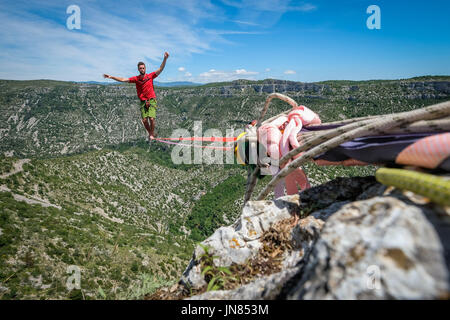 Nel sud della Francia, diversi membri del francese extreme sports team sangle dessus dessous, installare e camminare il più lungo mai slackline nel circo di Navacelles (mondo patrimonio umanità) a 300 metri di altezza. La highline è il più lungo mai truccate, 1662 metri, 1 miglio a. Nathan Paulin è il secondo per attraversare la linea, egli è il mondo recordman titolare. Navacelles - Francia - giugno 2017. Dans le sud de la France, plusieurs membres de l'équipe de sport extrême ont installé et traversé la plus longue slackline du monde dans le Cirque de Navacelles (sito inscrit au patrimoine mondiale de l'Unesco). La Foto Stock