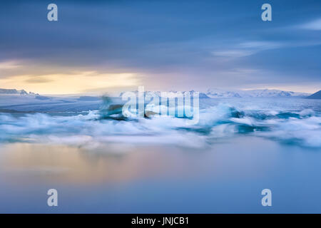 Jokulsarlon Iceberg laguna lunga esposizione al tramonto che mostra il movimento di iceberg in acqua, Islanda Foto Stock