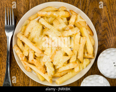 Ciotola di fritto e grigliate di formaggio chips contro un legno scuro dello sfondo di quercia Foto Stock