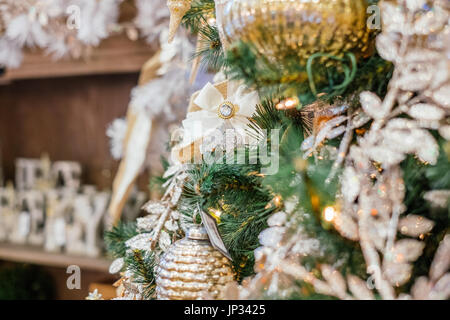 Addobbi per l'albero di natale e le luci appese su un tradizionale albero di Natale durante la stagione di festa di natale. Foto Stock