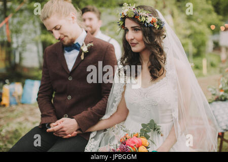 Si alternano sposi alla cerimonia di matrimonio all'aperto, metà ritratto Foto Stock