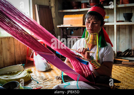 Lago Inle, Myanmar, sud-est asiatico. Tribù Padaung donna che lavorano al telaio. Foto Stock