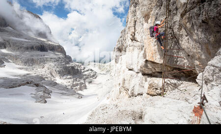 Una vista di un escursionista scendendo da una scala verticale sulla famosa via ferrata Bocchette "' sul Gruppo del Brenta, provincia di Trento, Trentino Alto Adige, Italia, Europa Foto Stock