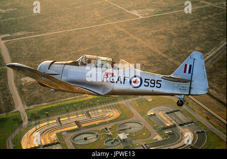 RCAF North American T-6 Harvard Mk IV / 4 battenti oltre a opere di fognatura al crepuscolo Foto Stock