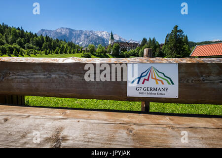 Schloss Elmau hotel,segno sulla panca in legno osservando la scena del vertice G7 2015, Baviera, Germania Foto Stock