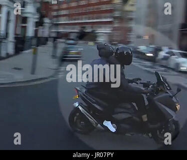 La migliore qualità disponibile nella schermata immagine catturata tratto dal video rilasciato dalla Polizia Metropolitana di ciclomotore-riding ladri in fuga dopo spegnimento di un uomo con il liquido in prossimità della Londra magazzini Harrods. Foto Stock