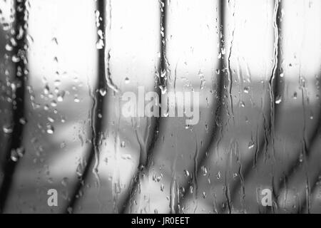 In bianco e nero di pioggia caduta contro una finestra - Concetto di pioggia Foto Stock