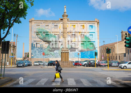 Sassari Sardegna street, vista della colonna che ritraggono la storia di Sassari con un grande murale di una tartaruga in background, Corso Francesco Vico. Foto Stock