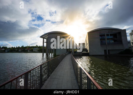 Islanda - Reykjavik city hall dal lago Tjornin con Sun Foto Stock