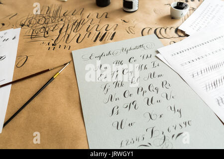 La pittura, la creatività, la decorazione di concetto. è semplice ma molto bello e armonioso della sceneggiatura del ben noto latino lettere scritte sulla barra grigia cartoncino pesante carta con notte inchiostro nero Foto Stock