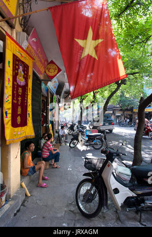 Il Vietnam bandiera in mezzo alla folla strade di Hanoi vietnam Foto Stock