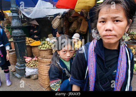 Le donne dal nero hmong gruppo etnico vendita di verdure fresche a bac ha mercato, sapa regione, lao cai provincia, Vietnam Foto Stock