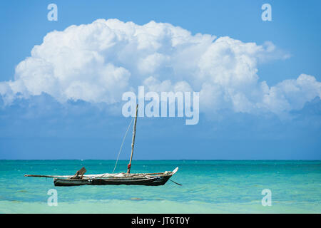 Sambuco tradizionale di pesca in legno barca ancorata off shore con le nuvole in backgroun, Diani, Kenya Foto Stock