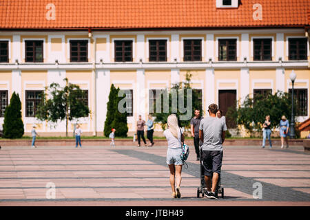 Grodno, Bielorussia - Giugno 11, 2017: famiglia giovane coppia con un passeggino a piedi nei pressi della Vecchia casa di Vice - Amministratore nella soleggiata giornata estiva in Hrodna, Bel Foto Stock